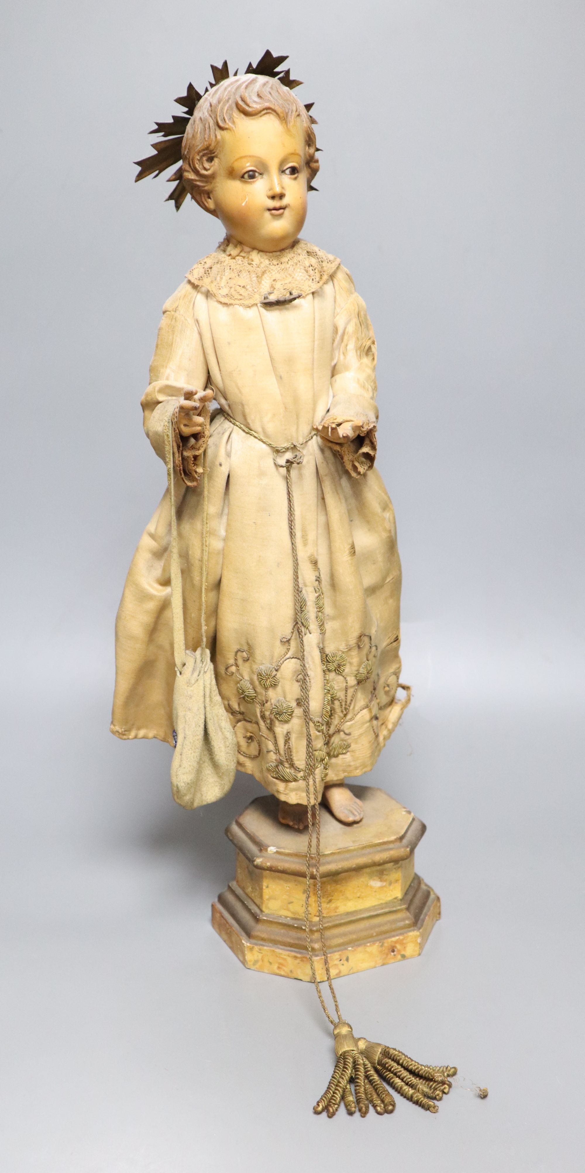 A late 19th century Continental carved and painted wood statue of a Saint, on a plinth base, height 49cm